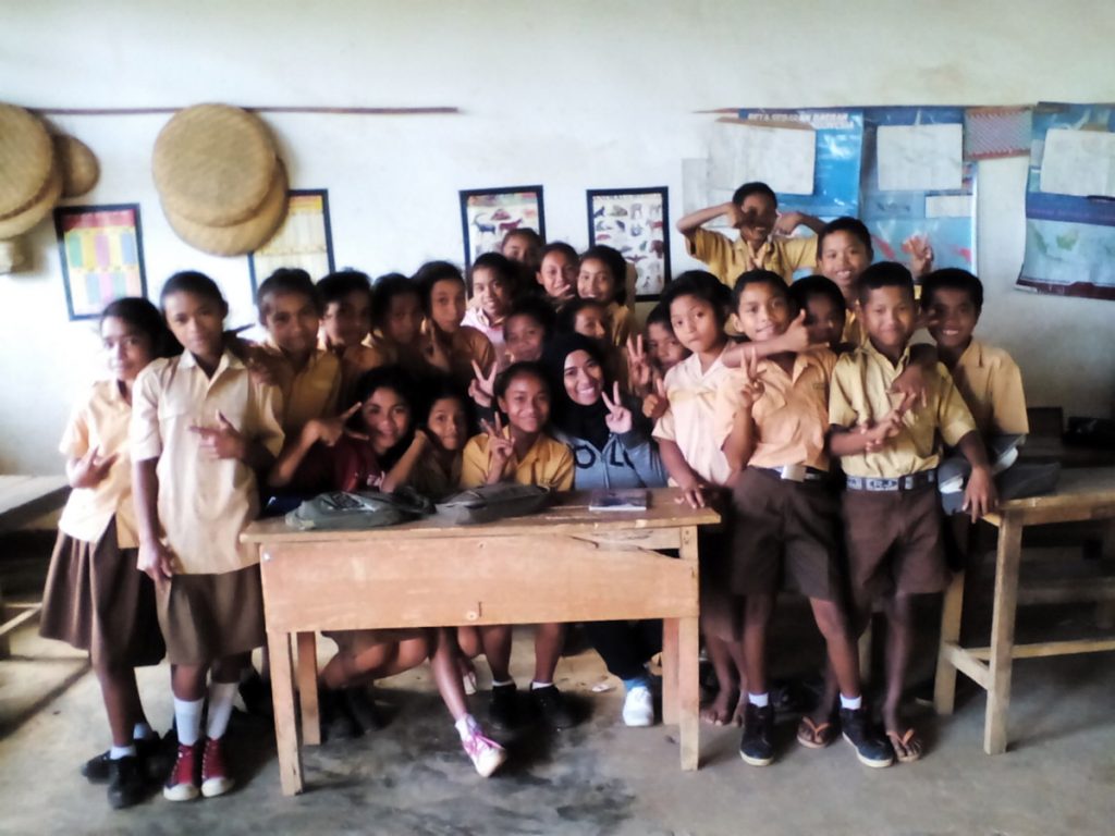 Taking a photo with kids from Grade 6 after playing games, singing and dancing at Lembor Sub-district
